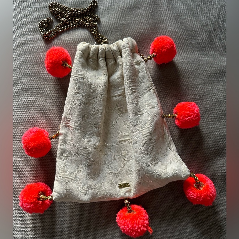 GAIA, empowered women, brass chain and fun Pom Poms for pop of color